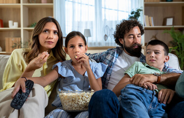 Family enjoying movie at home together