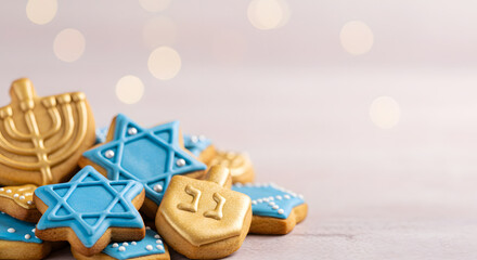 Decorated Hanukkah cookies with icing shaped like holiday symbols for celebration