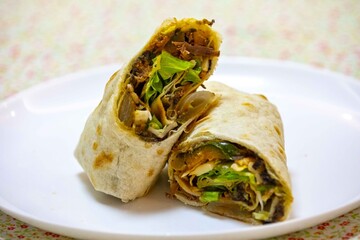 Traditional Mexican food, fajita, tortilla with meat, guacamole, black bean chili and salad
