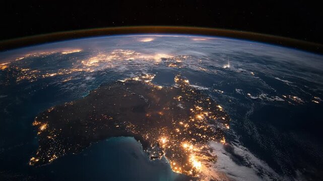 Earth's night side view reveals Australia lit by city lights, curved horizon, and starry space above