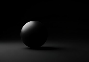A single dark sphere casting a subtle shadow on a black background with soft lighting highlighting its form