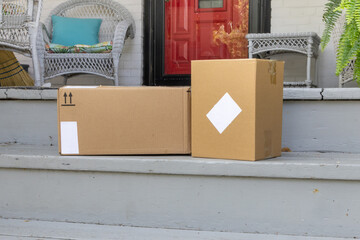 Two on line shopping delivery parcels on the front step of a house
