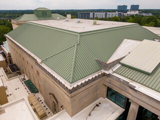 Daytime Drone Images of a Large Commercial Roof on a Performing Arts Center in Downtown Raleigh North Carolina on a Cloudy Day. The Roof Features TPO and Standing Seam Metal. 