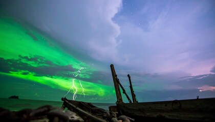 A dramatic display of vibrant green aurora borealis lighting up a stormy sky above an old fishing boat.