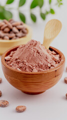 A clay brown deep plate is filled with cocoa powder and a wooden spoon. Light background, surrounded by cocoa beans