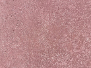 Light pink stucco wall texture, rough plaster surface, pastel background, building material