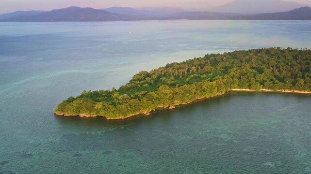 Siladen island in Bunaken National Park - marine park in the north of Sulawesi Island, Indonesia, very rich coral ecosystem dominated by fringing reef and barrier reef corals, aerial view of island.
