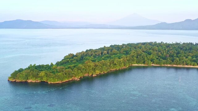 Siladen island in Bunaken National Park - marine park in the north of Sulawesi Island, Indonesia, very rich coral ecosystem dominated by fringing reef and barrier reef corals, aerial view of island.