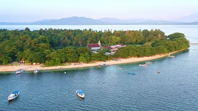 Siladen island in Bunaken National Park - marine park in the north of Sulawesi Island, Indonesia, very rich coral ecosystem dominated by fringing reef and barrier reef corals, aerial view of island.