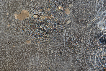 Abstract rippling water surface with light reflections creating intricate patterns. Captivating natural texture ideal for artistic designs, backgrounds, or displaying the beauty of nature.