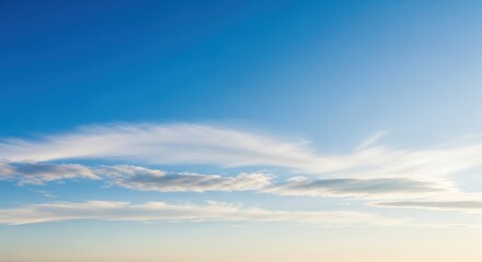 Fototapeta premium Serene Blue Sky with Wispy Clouds at Sunset, Soft Light