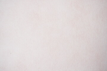 Abstract white fabric surface with small red dot pattern overall
