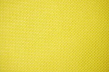 Close-up of textured yellow material with a detailed surface pattern