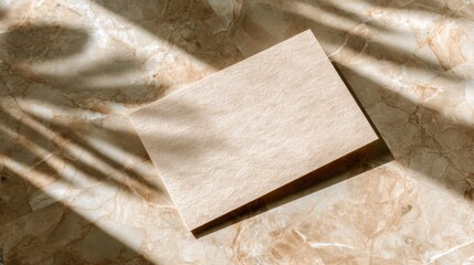 Minimalist Blank Card on Warm Marble Surface with Soft Shadows and Natural Light