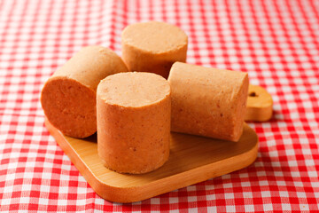 Brazilian peanut candy, traditionally known as pacoca or pacoquinha, on a wooden table