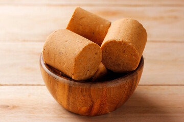 Brazilian peanut candy, traditionally known as pacoca or pacoquinha, on a wooden table