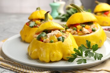 Tasty stuffed pattypan squashes on grey table, closeup