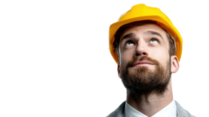 Male engineer in a suit wearing a hard hat, looking up in thoughtful contemplation.