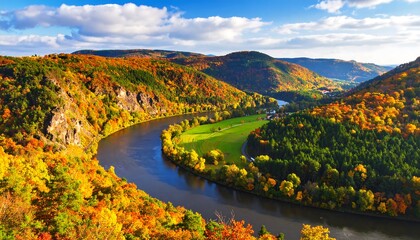 Obraz premium Majestic River Valley in Autumn Splendor with Vibrant Fall Foliage and Rolling Hills.