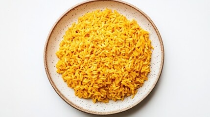 A top down view of a bowl of yellow rice on a speckled plate against a white background surface
