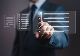 Businessman using digital checklist interface with virtual touch screen for project planning, task...
