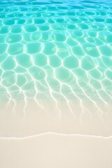 Obraz premium Aerial view of pristine tropical beach with calm, clear turquoise ocean water gently lapping on white sand, creating beautiful sunlit ripples and mesmerizing patterns