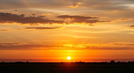 Fototapeta premium Golden hour sunset illuminating the horizon with a radiant glow, casting long shadows across the vast expanse