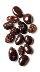 Pile of dark chocolate covered raisins and dried raisins on a white background
