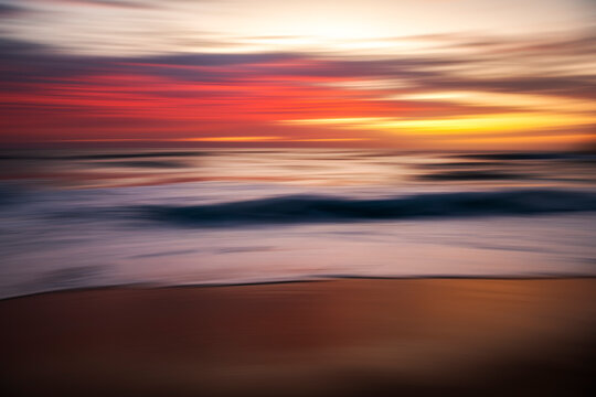 Slow shutter speed image of sunrise over the ocean at Bronte Beach, Sydney, Australia, creating a dreamy blurred effect. - Powered by Adobe