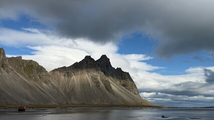 storm clouds over the sea with icelandic mountain