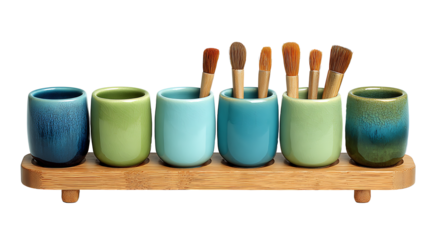 Set of colorful blue and green ceramic cups with art and makeup brushes on wooden stand. Isolated on Transparent background. High quality PNG file