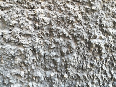 Close-up view of stacked concrete slabs with rough texture and horizontal line patterns. The industrial background shows the raw surface of building materials, ideal for use in construction themes.