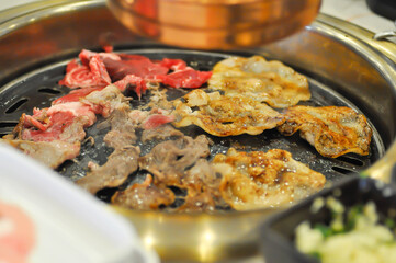 barbecued beef or grilled beef and grilled pork on the broiler or Korean bbq