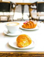 Coffee and croissants on a cafe table