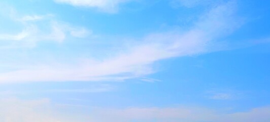 Fototapeta premium Panorama view of bright blue sky with fluffy white clouds on a clear sunny day. Sky panorama clear blue with white clouds in spring. Cloudscape