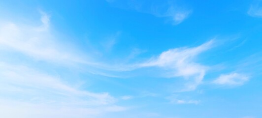 Panorama view of bright blue sky with fluffy white clouds on a clear sunny day. Sky panorama clear blue with white clouds in spring. Cloudscape. Clear blue sky, bright spring, wallpaper landscape.