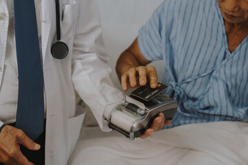 Patients are using money and credit cards to pay for medical services after successful treatment.