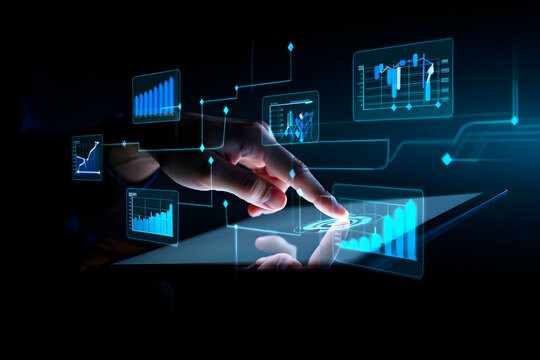 Hand Interacting With Futuristic Digital Interface Displaying Financial Charts and Graphs on a Tablet