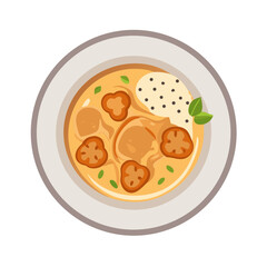 Overhead shot of orange soup with dumplings in bowl