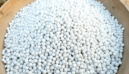 White spherical granules in a wooden bowl