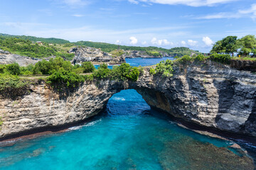 Natural Rock Arch Over Turquoise Sea at Nusa Penida, Bali, Indonesia