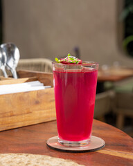 Beetroot Cocktail in a Tall Glass on a Table in a Tropical Bar