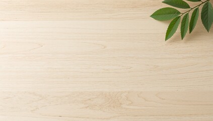 Wood background with green leaves on light wood surface top view
