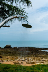 Tropical beach paradise outdoor shower with palm trees and sea views
