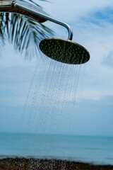 Tropical beach paradise outdoor shower with palm trees and sea views