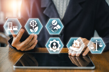 Businessman using digital icons to explore real estate investment trust strategies and financial growth on a tablet.