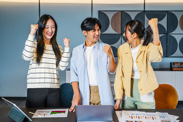 Vibrant business team consisting of diverse individuals joyfully raises their fists in celebration of a significant achievement, Celebrating success in a business team with joyful expressions