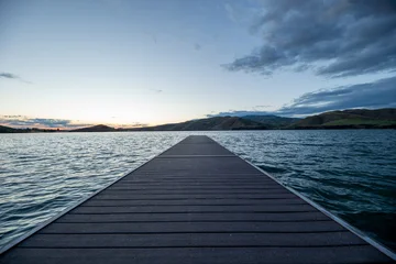 Fototapeten Pier A pier is seen in front of a body of water  © Tracy King
