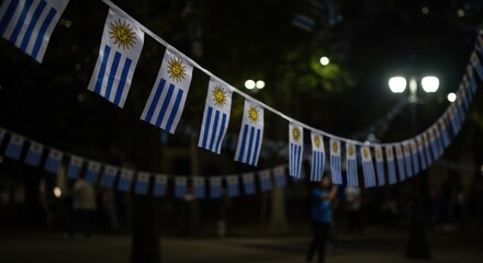 A Nighttime Celebration with Uruguayan Flags Displayed Vibrantly Under City Lights