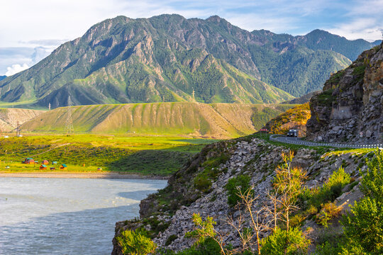 Summer landscape with Chuysky trakt road and Katun river among Altai mountain in Altai republic, Russia. View on Saljar ridge, Kuytash mountain and stone gates of Airy-Tash in Altai, Siberia